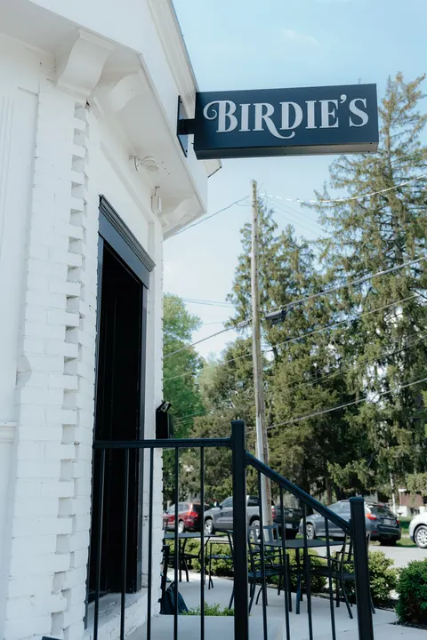 Birdie's Coffee Co. founders smiling together inside their café space.