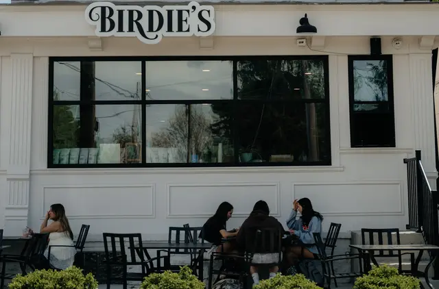 Exterior shot with people outside sitting at tables